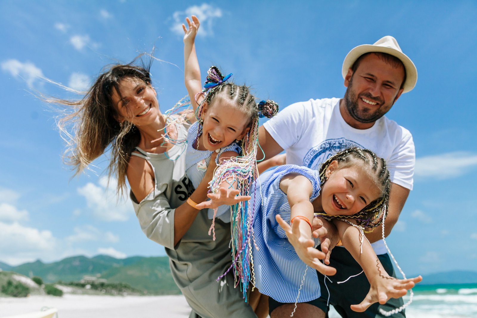 A smiling family playing together on a sunny beach