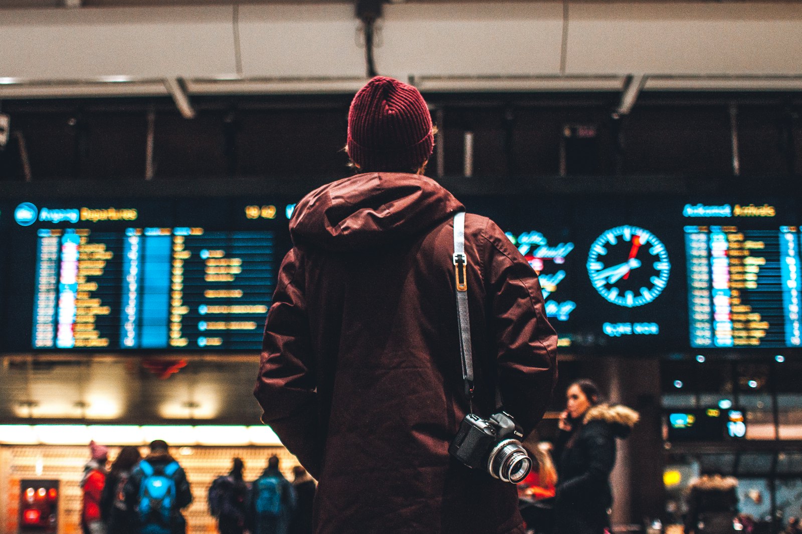 A business traveller checking the departures board at an airport